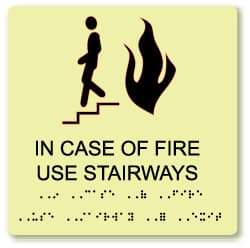 NMC - In Case of Fire - Use Stairway, Plastic Fire Sign - 8" Wide x 8" High, English/Braille, Glow-in-the-Dark - Americas Industrial Supply