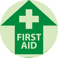 NMC - Adhesive Backed Floor Signs; Message Type: First Aid ; Graphic Type: Cross in Up Arrow ; Message or Graphic: Message & Graphic ; Legend: First Aid ; Color: Green; White ; Special Color Properties: Glow-In-The-Dark - Exact Industrial Supply