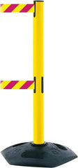 Tensator - 38" High, 2-1/2" Pole Diam, 4 Way Stanchion - 19" Base Diam, Octagon Recycled Rubber Base, Yellow Plastic Post, 13' x 2" Tape, Dual Line Tape, For Outdoor Use - Americas Industrial Supply
