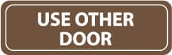 NMC - Use Other Door, 11" Wide x 3.5" High, Acrylic Sign - English, White on Brown, Wall Mount - Americas Industrial Supply
